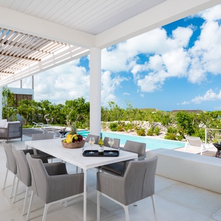 Dine al fresco on your private terrace with stunning ocean views and pool access.