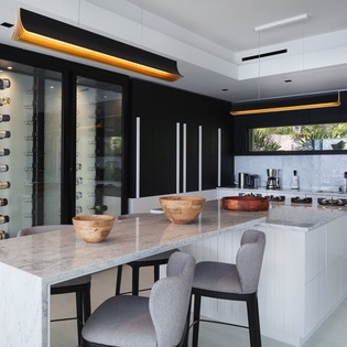 Your culinary sanctuary features a stunning marble island and climate-controlled wine display, perfect for memorable meals.