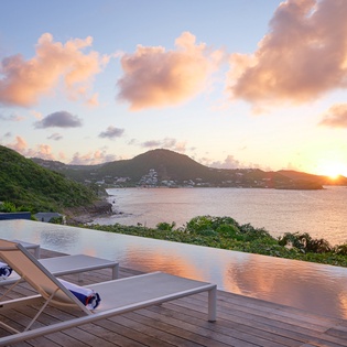 Breathtaking sunset views from this infinity pool deck, where golden skies paint the ocean horizon in spectacular Caribbean colors.