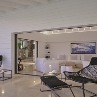 Relax in your elegant open-plan living space with designer furniture and seamless indoor-outdoor flow through expansive sliding doors.