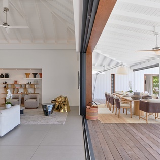 Bright, airy open-concept living that seamlessly blends indoor comfort with your private outdoor dining terrace under a vaulted ceiling.