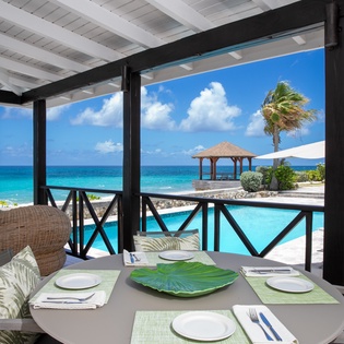 Dine al fresco with uninterrupted ocean views, swaying palms, and a refreshing pool steps away—your tropical escape awaits.