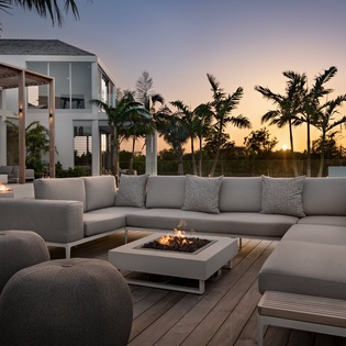 Unwind around the elegant fire pit as tropical palms frame stunning sunset views from your private outdoor sanctuary.