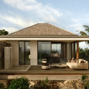 Modern tropical villa with outdoor terrace overlooking lush landscape and distant horizon.