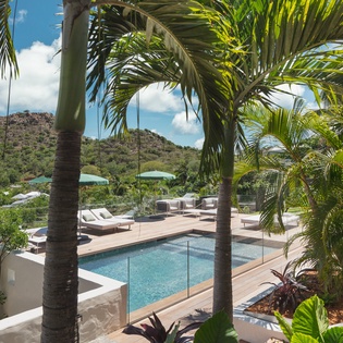 Tropical paradise awaits with your private pool surrounded by swaying palms and mountain views for ultimate relaxation.