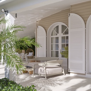 Step onto your private terrace where elegant lounge chairs await beneath graceful arched doors and swaying palm shadows.