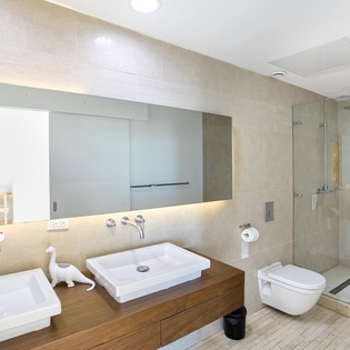 Indulge in your spa-like ensuite with dual vanities, rainfall shower, and sleek modern finishes - pure luxury awaits.