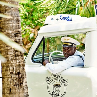 Tropical transport awaits with friendly local service under swaying palms.