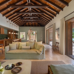 Soar beneath stunning exposed wood beams in this airy open-plan space where your living, dining, and kitchen flow seamlessly together.