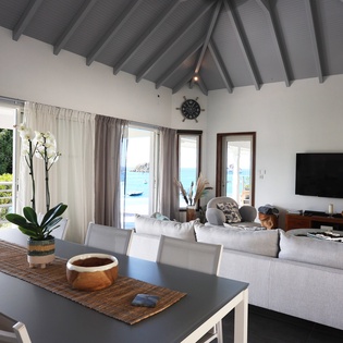 Relax in this stunning open-plan living space where vaulted ceilings and panoramic sea views create your perfect island retreat.