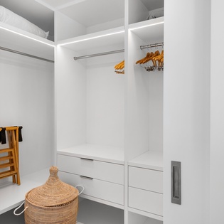 Your spacious walk-in closet offers abundant storage with hanging rods, built-in drawers, and shelving to keep your belongings perfectly organized.