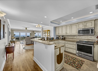 Prepare your favorite meals in this spacious gourmet kitchen with granite countertops, modern appliances, and a breathtaking ocean view that stretches beyond your living space.