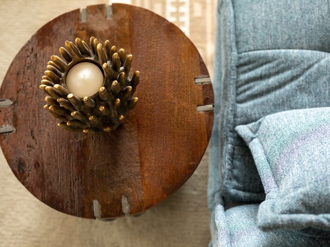 Curl up with a book or enjoy your morning coffee at this handcrafted wooden table, where rustic charm meets modern comfort in your cozy retreat.