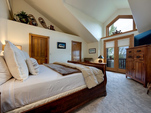 Drift off in your spacious bedroom, where vaulted ceilings create an airy feel and natural light pours in through beautiful wood-framed glass doors opening to your private balcony with wooded views.