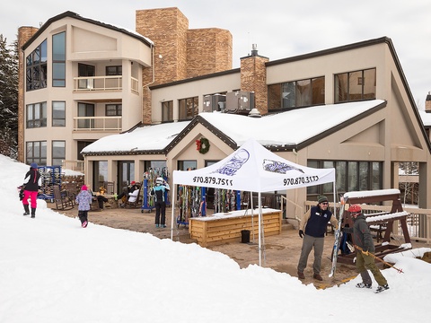 A premier ski-in/ski-out property nestled in a winter resort village, featuring direct slope access, on-site rental shop, and festive alpine architecture surrounded by pristine snow.