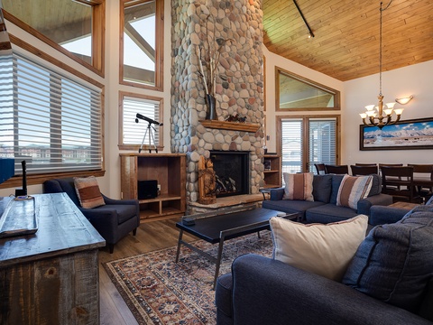 Gather by the towering stone fireplace or sink into plush seating with cathedral ceilings and warm wood surrounding you. Your mountain escape awaits in this inviting great room.