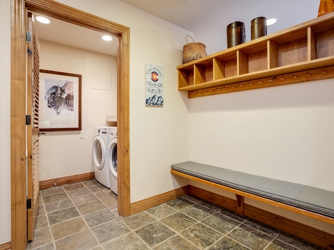 Store your gear on custom wooden cubbies with hooks, settle onto the built-in bench, and keep everything fresh with in-unit washer and dryer tucked just beyond the mudroom.