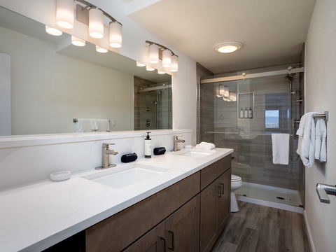 Step into your beautifully appointed private bathroom with dual vanities, modern fixtures, and a spacious walk-in shower—designed for your comfort and relaxation.