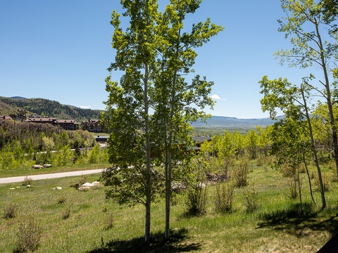 Expansive mountain landscape with rolling hills, aspens, and scenic valleys visible from the property's neighborhood setting.