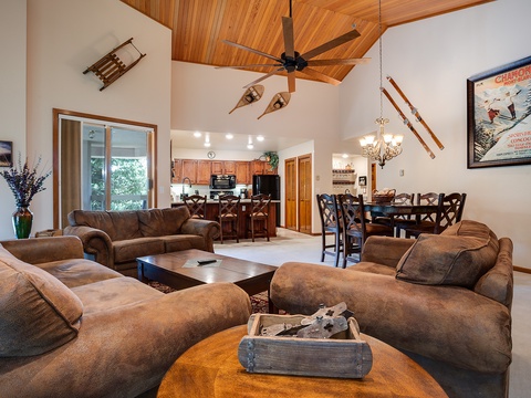 Sink into plush seating beneath soaring wood ceilings where the living, dining, and kitchen flow together—your home base for mountain memories and après-ski gatherings.