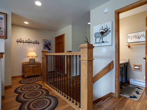 Step into your welcoming hallway, where warm wood accents and mountain-inspired art create a cozy alpine retreat that feels like home from the moment you arrive.