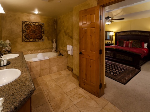 Unwind in your luxurious en-suite with a soaking tub, dual vanities, and elegant finishes connecting seamlessly to your restful bedroom retreat.