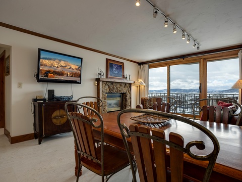 Gather around the handcrafted dining table with mountain views stretching beyond your windows. Your fireplace awaits cozy evenings, while the balcony invites fresh alpine air into your retreat.