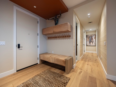 Step inside and feel instantly at home in your warm, modern entryway with custom wood storage and a welcoming bench where you can settle in after your adventures.