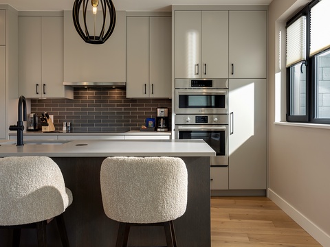 Step into your sleek, fully-equipped kitchen where light pours in as you cook—modern appliances, polished counters, and a cozy breakfast bar await your mornings.