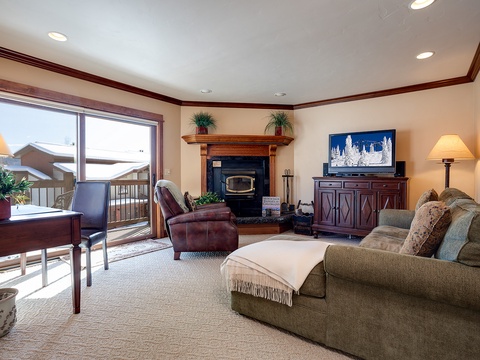 Settle into your private living room, where a cozy fireplace, plush seating, and TV create the perfect spot for unwinding after mountain adventures.