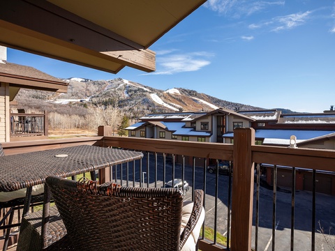 Snow-capped mountains frame your private balcony, where wicker seating invites morning coffee under mountain sunshine and crisp alpine air.