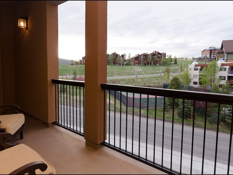 Your private balcony overlooks scenic rolling hills, neighboring residences, and lush greenery—perfect for morning coffee or unwinding after exploring the area.