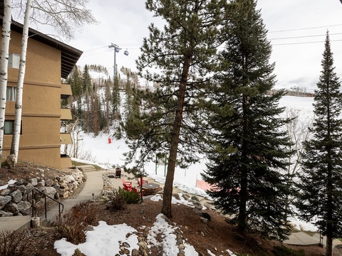 Mountain retreat surrounded by towering pines and ski slopes, perfect for winter getaways with easy slope access.