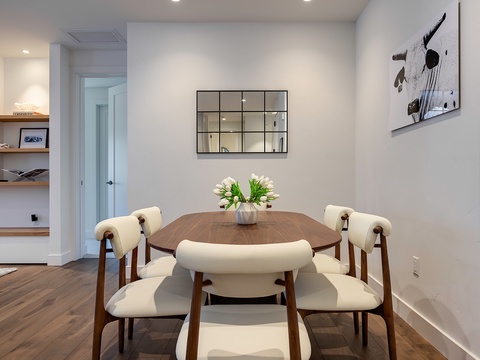 Gather around this inviting dining table, where fresh flowers and warm walnut tones set the stage for memorable meals with your favorite people.