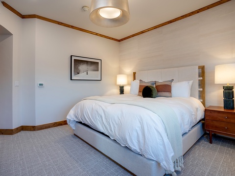 Sink into crisp linens and plush pillows after your day exploring. Warm wood tones and soft lighting create a peaceful retreat where you'll sleep soundly.