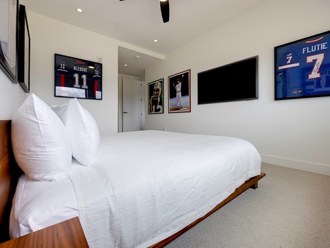 Sink into the plush white bedding and surround yourself with sports memorabilia that brings personality and energy to your space.