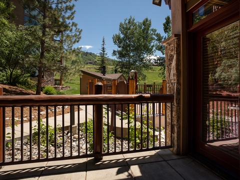A peaceful mountain setting framed by tall pines and lush greenery, offering a tranquil backdrop for your stay in this alpine community.