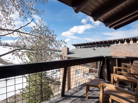 Sit back on your private balcony and soak in crisp alpine air, snowy slopes in the distance, and the serene beauty of tree branches framing bright blue skies overhead.