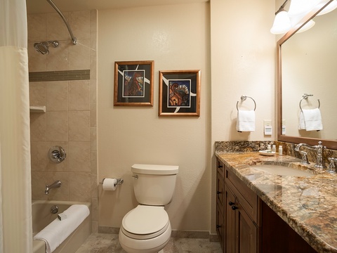 Refresh in your private bathroom with a spacious tub-shower, elegant granite vanity, and thoughtfully appointed details for your comfort.
