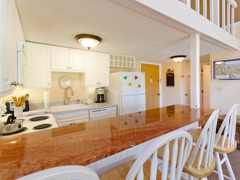 Cook your favorite meals in this fully equipped kitchen with modern appliances, gleaming countertops, and a breakfast bar perfect for your morning coffee.