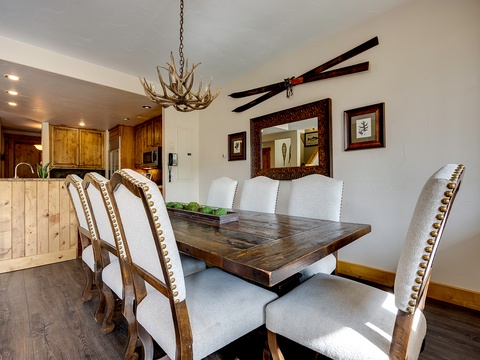 Gather around this handsome rustic dining table, where an antler chandelier and mountain lodge decor set the stage for memorable meals with your group.