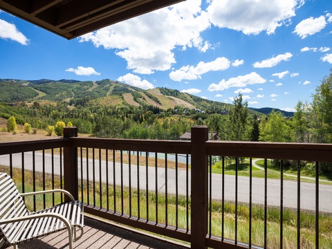 Enjoy your morning coffee overlooking the stunning mountain landscape and ski slopes. Your private balcony offers panoramic views of lush forests and rolling hills under endless blue skies.