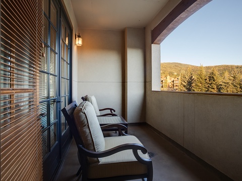 Unwind on your private balcony with mountain views, where cozy seating invites you to soak in the peaceful scenery and fresh alpine air.
