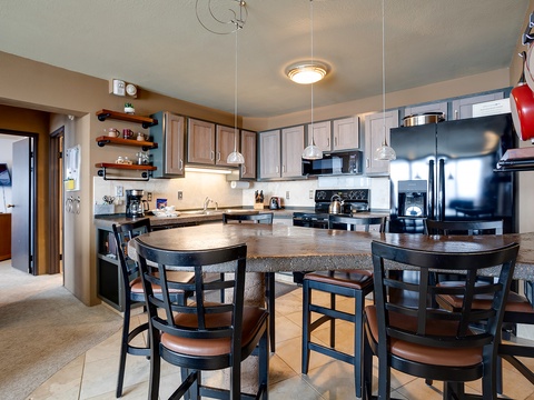 Your spacious kitchen features a grand island with seating for six, stainless steel appliances, and abundant counter space—perfect for preparing meals and gathering with friends and family.