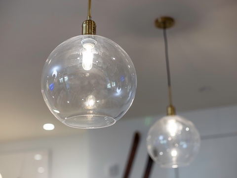 Elegant glass pendant lights create a warm, modern ambiance throughout your space, blending style with soft illumination.