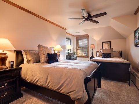Drift off to sleep in this cozy bedroom, where two plush beds and soft lighting create the perfect retreat after your mountain adventures.