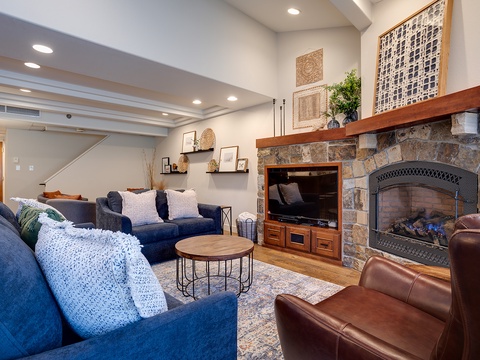 Unwind in your spacious living room, where plush sofas invite you to relax by the stunning stone fireplace, creating the perfect cozy retreat after a day of adventure.