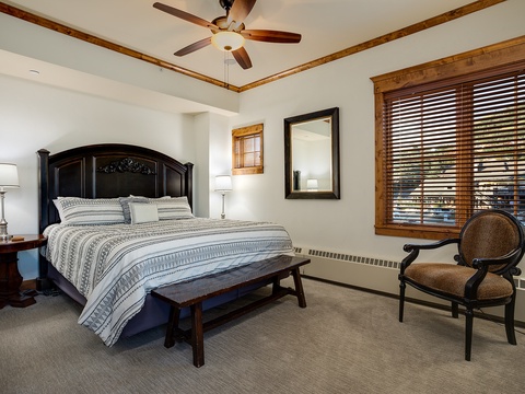 Sink into crisp linens and drift off under the gentle breeze of your ceiling fan, while warm wood accents and soft lighting wrap you in comfort.