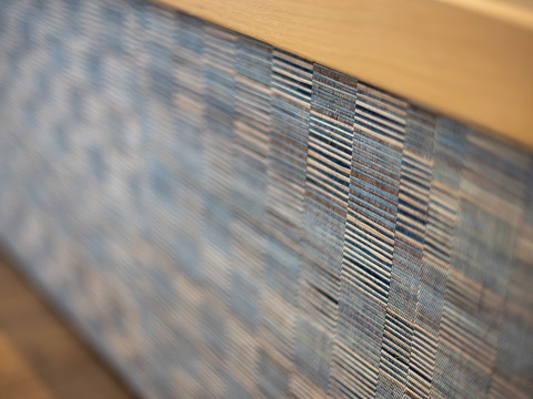 This photo shows an extreme close-up of a monitor screen displaying what appears to be a textured pattern or fabric, with visible pixelation and screen scan lines.