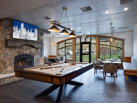 Unwind in this inviting lounge with a game of billiards by the fireplace, or relax with a view of the surrounding landscape through elegant windows.
